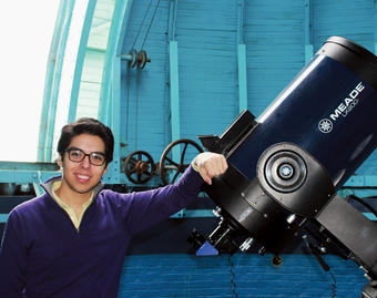 Bryan Terrazas ’13, shown here at the Rutherford Observatory atop Pupin Hall, has spent his undergraduate years  sampling various aspects of astrophysics.Photo: Kristen Stryker